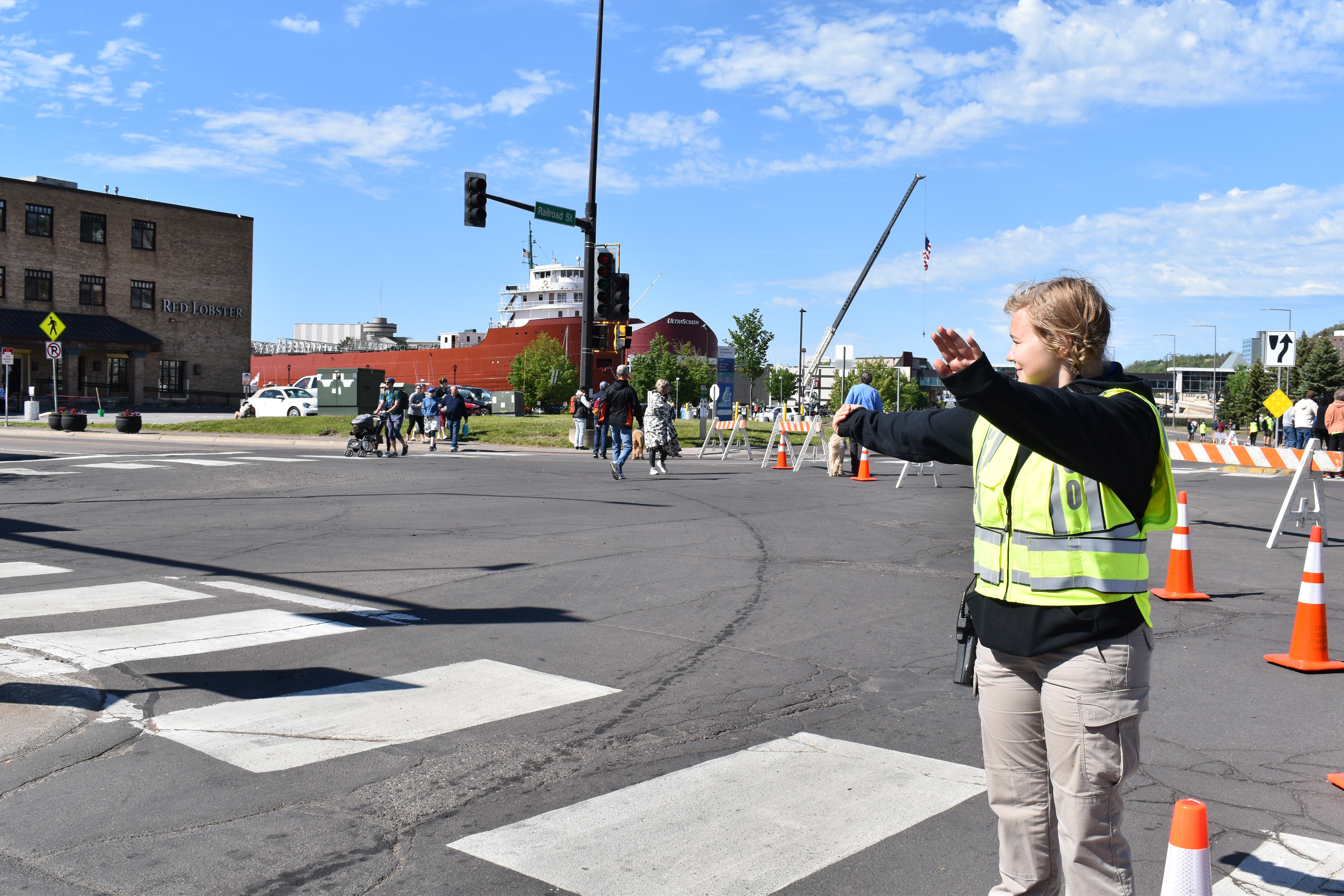 Community Service Officer-Intern Katie Latourelle (who is now a sworn police officer) helps direct traffic during the Grandmas Marathon.