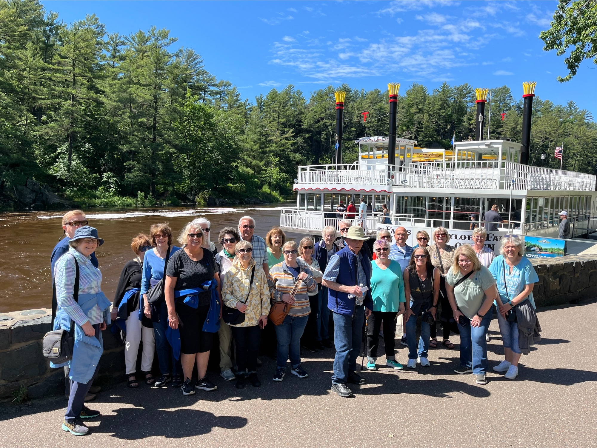 A group stops for a photo at the Taylors Falls River Boat Senior Day Trip