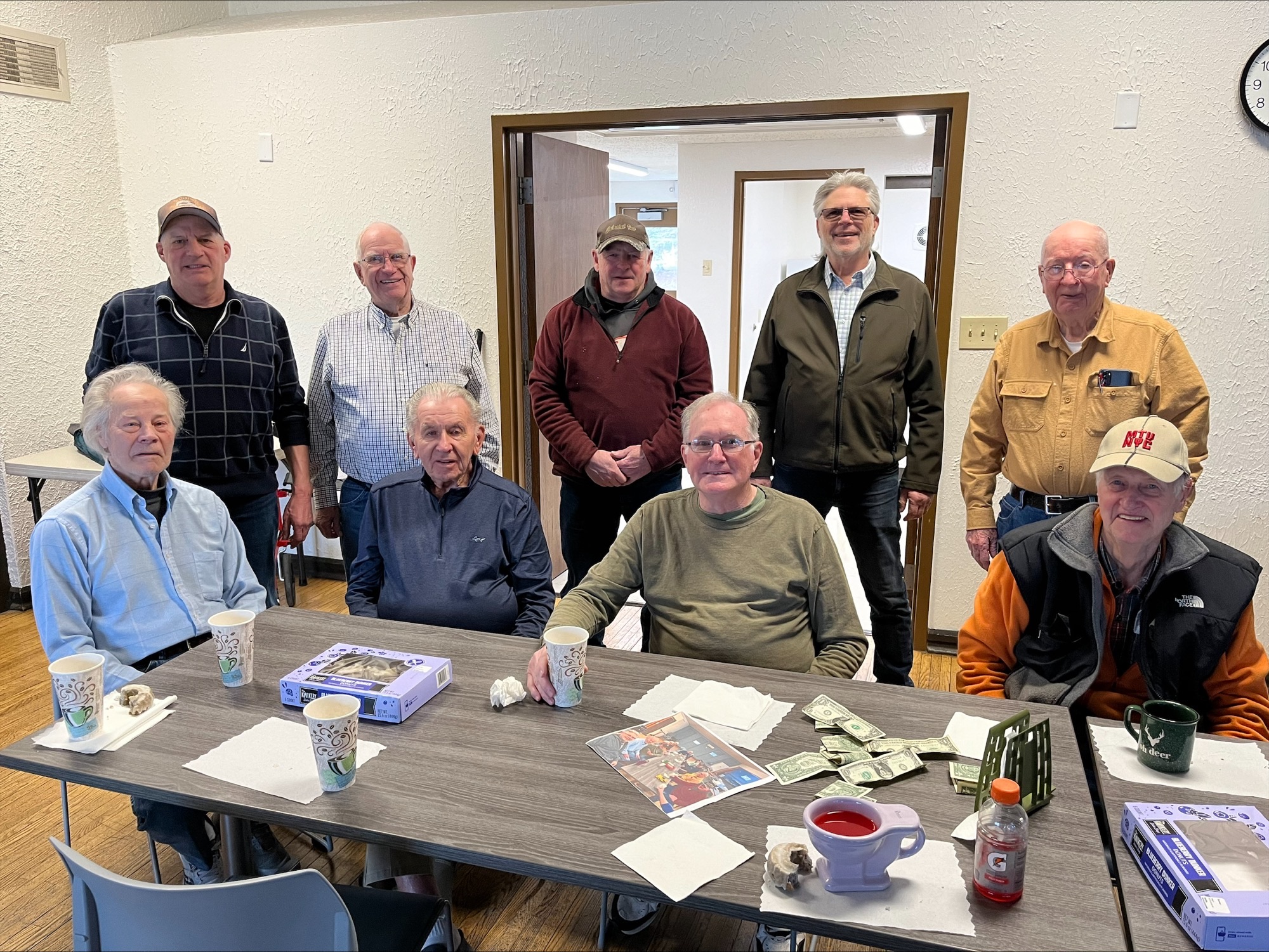 Men's Coffee and Chat conversation group posing for a photo at Portman Community Center