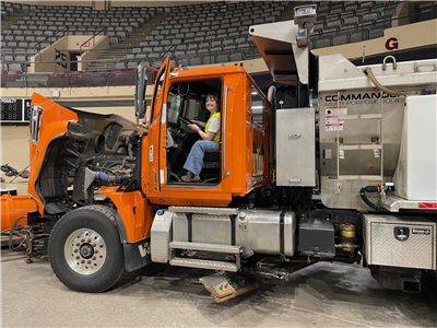 Student simulating driving a snow plow