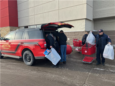 DFD employees loading a vehicle with toys purchased for toy drive